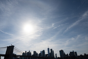 Lower Manhattan skyline and Brooklyn Bridge, seen from Brooklyn in the late afternoon, with the sun low in the sky (June 2022)