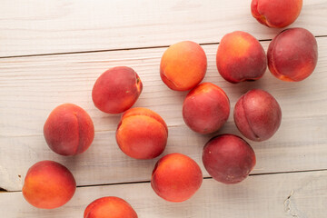 Several organic apricot reds  on a wooden table, close-up, top view.