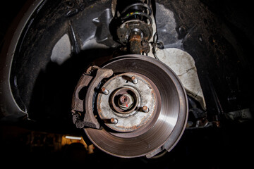 Disc brake of the vehicle for repair. Car on a lift.