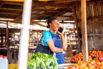 African woman making phone in the market