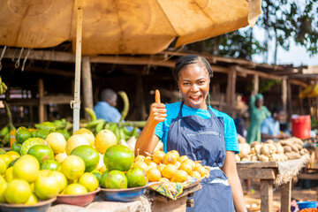 over excited African market woman doing thumbs up