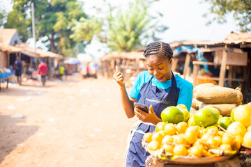 over excited African market woman using mobile phone
