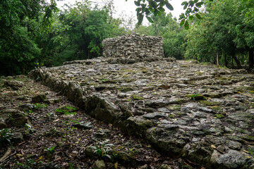The ruins of an ancient Mayan altar in the jungle. Stone ruins after a downpour in the forest. Yucatan, Mexico.
