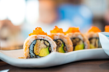 Philadelphia roll sushi with salmon, cucumber, avocado, cream cheese and caviar. Japanese food.