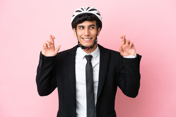 Argentinian businessman with bike helmen isoleted on pink background