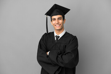 Young Argentinian university graduate isolated on grey background with arms crossed and looking forward