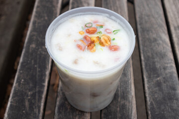 Chinese Congee with Beef Squid and Pork in a Plastic Container
