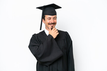 Young university graduate man isolated on white background looking to the side