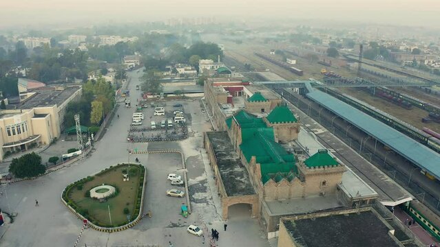 Aerial view of Rawalpindi Railway station with buildings, trees and parked cars in Pakistan
