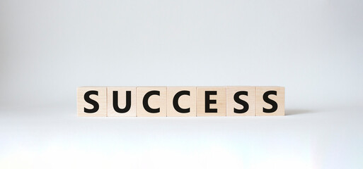 Success symbol. Wooden blocks with word Success. Beautiful white background. Business and Success concept. Copy space.