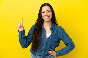 Young caucasian woman isolated on yellow background pointing up a great idea