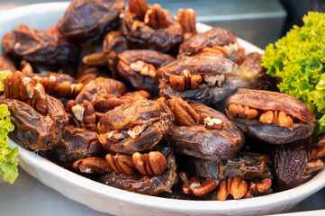 Turkish or arabic sweet dessert, ripe dried dadels with walnuts sweetened with syrup or honey.