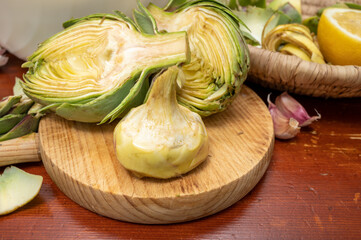 Cooking of green heads of artichokes plants, how to peel artichoke