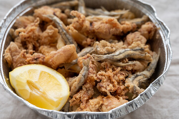 Spanish sea food, cripsy deep fried baby octopus, fish, calamari rings served with lemon