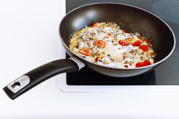 Omelet with tomatoes and lentils for breakfast