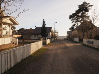 A street with wooden houses leading to a beach, Kallo Island, Finland, 