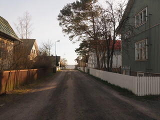 A street with wooden houses leading to a beach, Kallo Island Finland
