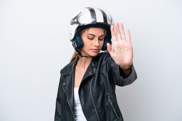 Young caucasian woman with a motorcycle helmet isolated on white background making stop gesture and disappointed