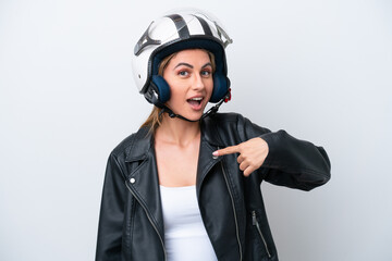 Young caucasian woman with a motorcycle helmet isolated on white background with surprise facial expression