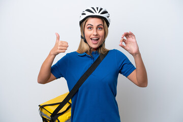Young caucasian woman with thermal backpack isolated on white background showing ok sign and thumb up gesture