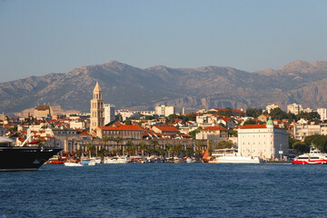 Promenade in Split, Croatia with landmark architecture and sailing boats.