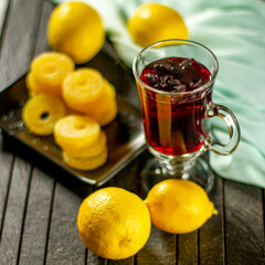 Creative layout made of cup of hibiscus tea and lemon on a table background. Top view.