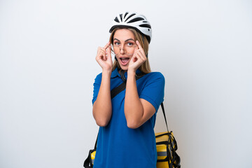 Young caucasian woman with thermal backpack isolated on white background with glasses and surprised
