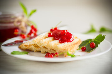 fried bread croutons for breakfast with redcurrant jam in a plate with berries