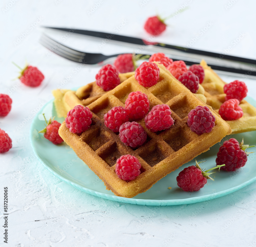 Poster stack of baked belgian waffles with ripe red raspberry