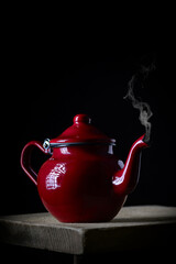 teapot in the foreground photographed in low light key..