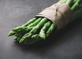 Fresh green asparagus sprouts on a wooden background. View from above