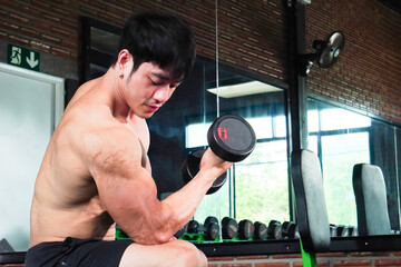 Asian man exercising, in the gym, dumbbells, sport, lifestyle, fitness, energy burning, wellness concept. health care  