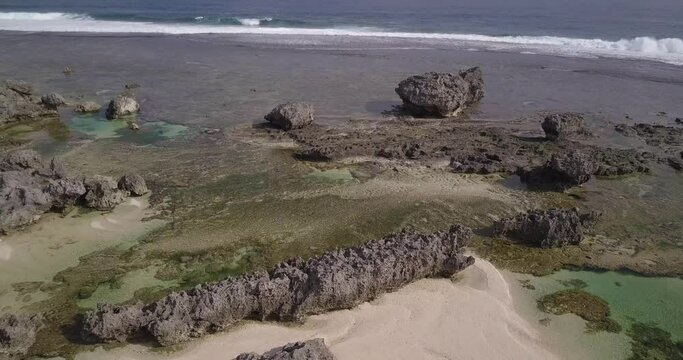 Drone footage of a body of water near the rocky shore in Batanes, Philippines