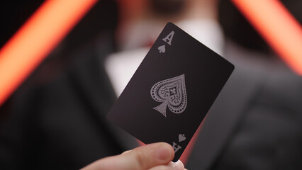 Gambler in business suit show ace card close-up