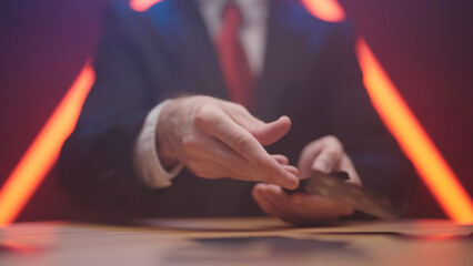 Businessman dealing black cards around the table