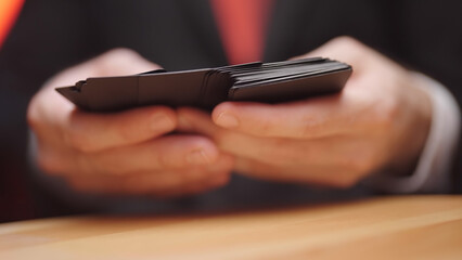 Hands search through deck of black cards