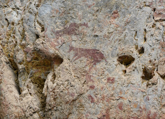 The Cliff of the Mountain Goat. Ancient wall paintings on limestone cliffs. Archaeological site of color paintings of Pratu Pha Camp of Lampang, Thailand.