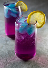 Bright refreshing cocktail. Pink lemonade with blue ice cubes. Galaxy lemonade. High quality photo