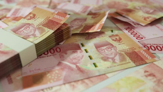 3D animation of Camera panning around spread Indonesian rupiah notes. Camera moving around Scattered rupiah notes on surface