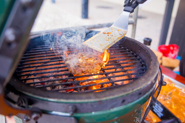 Flame grilled hamburger on a barbecue