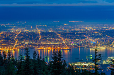 Fototapeta na wymiar Cityscape Night. Evening illumination in Vancouver, Canada. Aerial view.