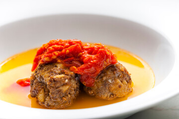 broth with meatballs and tomato sauce