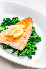 grilled salmon fillet with spinach leaves salad