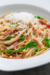 spaghetti with spinach, bacon and kernels