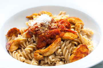 pasta fusilli with spicy chicken meat and tomato sauce