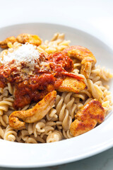 pasta fusilli with spicy chicken meat and tomato sauce
