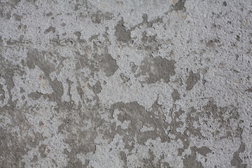 Dirty rough surface texture of sand screed cement, old gray concrete wall for background with uneven stains and tiny holes.