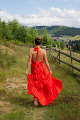 Fototapeta premium the girl is running in a red dress