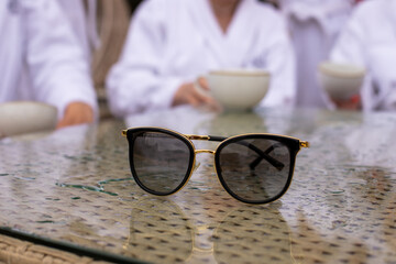 sunglasses on the background of women in robes