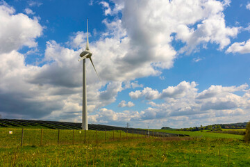 Fototapeta na wymiar Single Wind Turbine On farmland concept of clean energy production